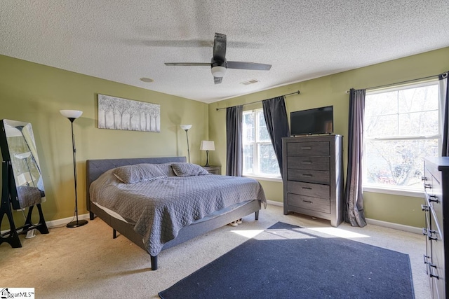 bedroom featuring carpet flooring, baseboards, a ceiling fan, and visible vents