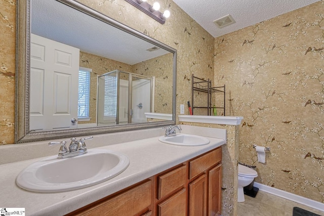 full bathroom featuring a sink, visible vents, a stall shower, and a textured ceiling