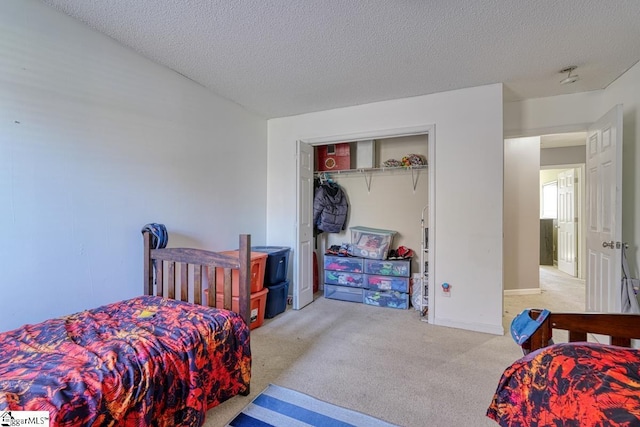 carpeted bedroom featuring a closet and a textured ceiling