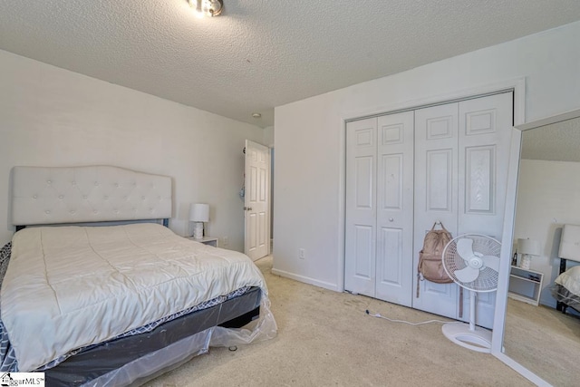 bedroom featuring a closet, carpet, and a textured ceiling
