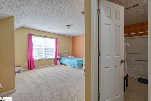 carpeted bedroom with visible vents, baseboards, lofted ceiling, and a textured ceiling