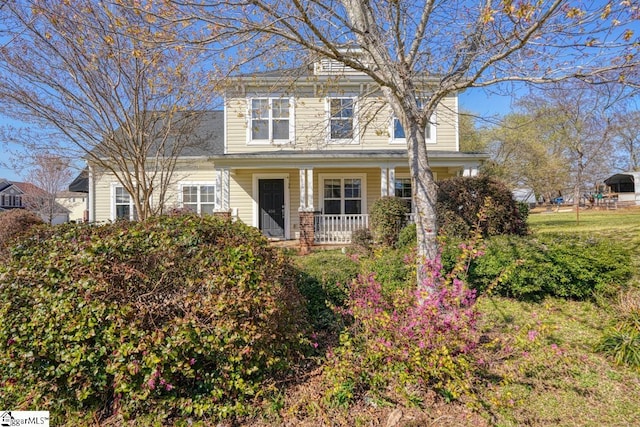 traditional style home featuring covered porch