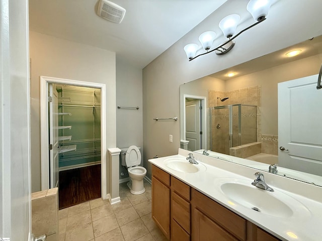bathroom with a shower stall, visible vents, tile patterned flooring, and a sink