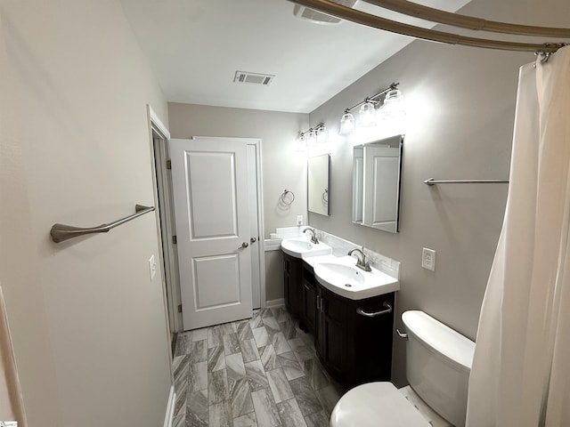 full bathroom with double vanity, visible vents, toilet, and a sink