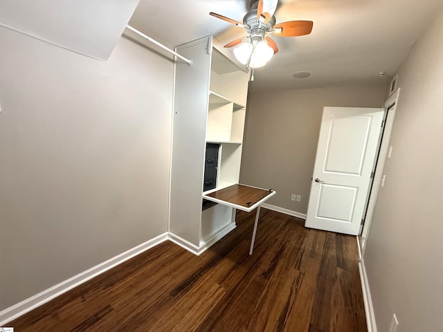 walk in closet with dark wood-type flooring and ceiling fan