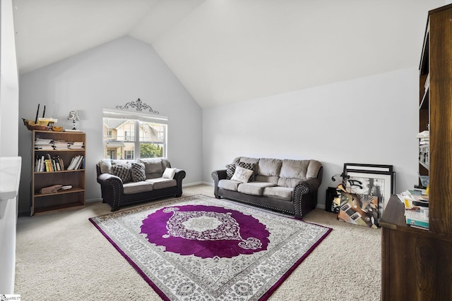 carpeted living room featuring high vaulted ceiling