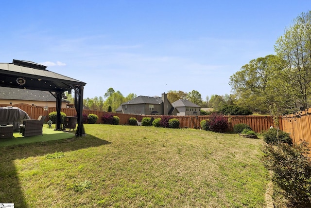 view of yard featuring a gazebo and a fenced backyard