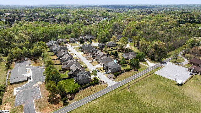 bird's eye view featuring a forest view and a residential view