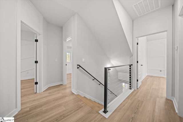 517 Windham Ln, Easley, SC 29642 - hall with an upstairs landing, visible vents, baseboards, and light wood-style flooring