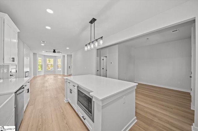 517 Windham Ln, Easley, SC 29642 - kitchen with dishwasher, open floor plan, light countertops, white cabinetry, and built in microwave