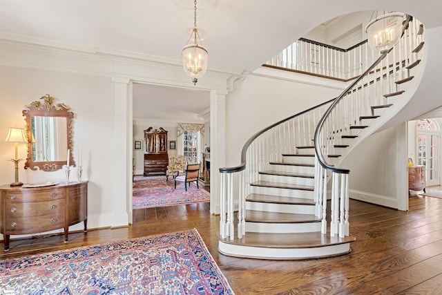 entrance foyer featuring ornamental molding, stairway, and hardwood / wood-style flooring