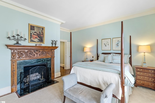 bedroom featuring carpet flooring, baseboards, ornamental molding, and a premium fireplace