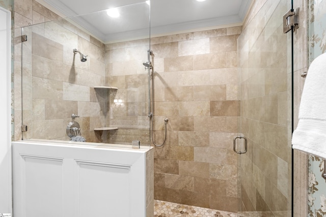 bathroom featuring ornamental molding and a stall shower
