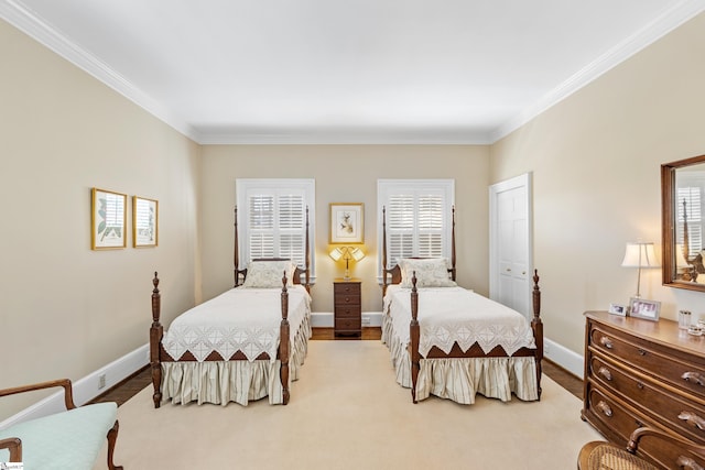 bedroom featuring ornamental molding, baseboards, and multiple windows