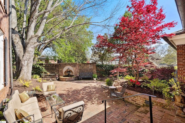 view of patio with an outdoor hangout area and fence