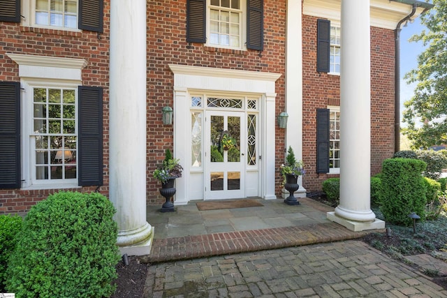 property entrance featuring brick siding