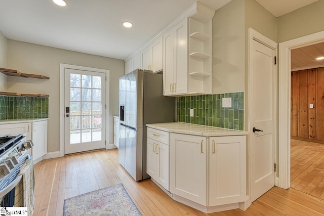 506 Parkview Dr, Spartanburg, SC 29302 - kitchen featuring light wood-style floors, open shelves, white cabinets, stainless steel appliances, and decorative backsplash