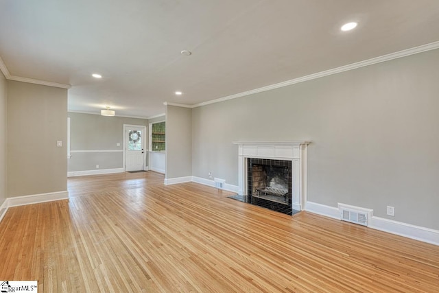 506 Parkview Dr, Spartanburg, SC 29302 - unfurnished living room featuring light wood-type flooring, ornamental molding, visible vents, a tiled fireplace, and baseboards