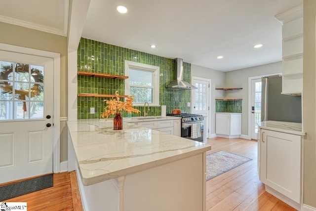 506 Parkview Dr, Spartanburg, SC 29302 - kitchen with wall chimney range hood, a peninsula, stainless steel range with gas cooktop, and open shelves
