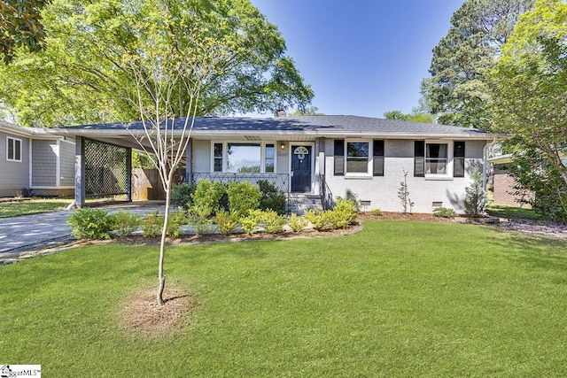 ranch-style house with an attached carport, a front yard, brick siding, and driveway