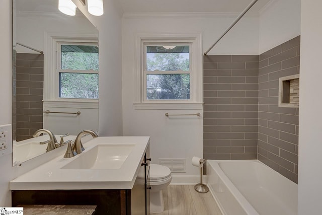 bathroom featuring a wealth of natural light, visible vents, ornamental molding, and toilet