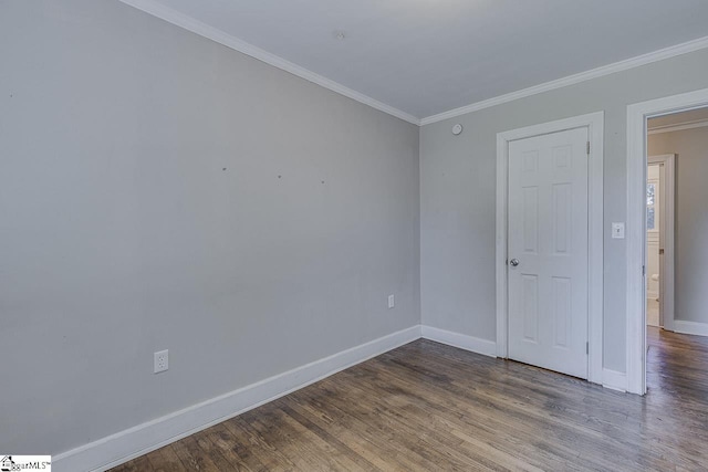 unfurnished bedroom featuring wood finished floors, baseboards, and ornamental molding