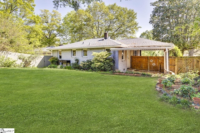 rear view of house with fence, a lawn, and a chimney