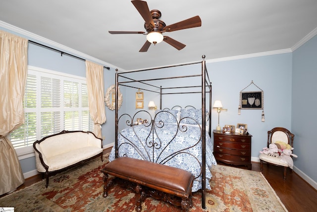 bedroom featuring crown molding, baseboards, ceiling fan, and wood finished floors