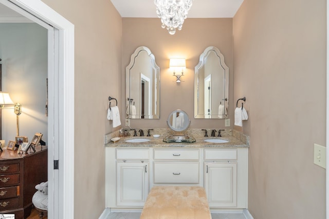 bathroom featuring double vanity, a sink, and an inviting chandelier