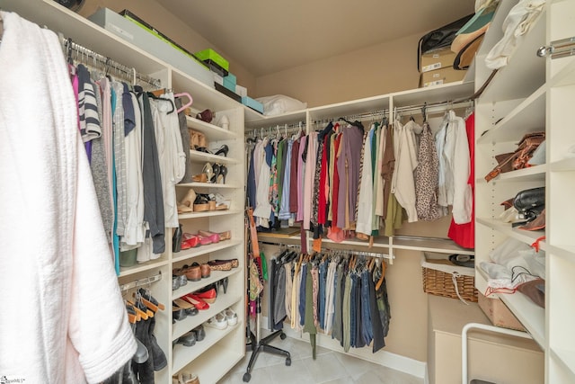 spacious closet with tile patterned floors