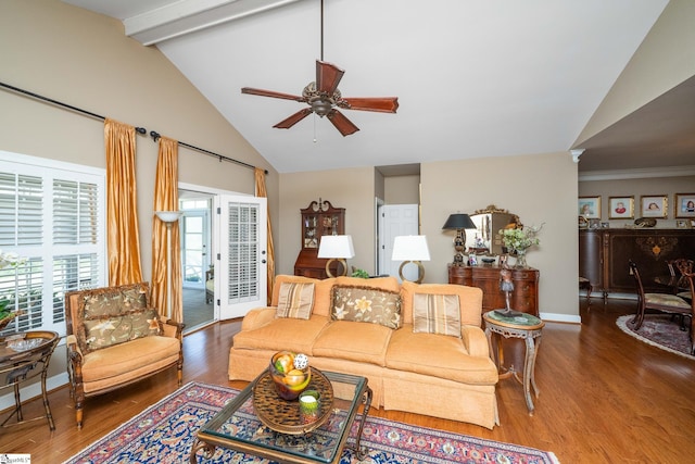 living room with beamed ceiling, baseboards, a ceiling fan, and wood finished floors