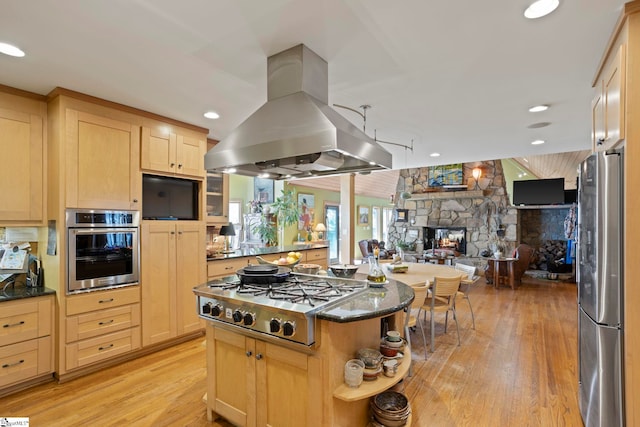 902 Altamont Rd, Greenville, SC 29609 - kitchen with light brown cabinetry, light wood finished floors, appliances with stainless steel finishes, open floor plan, and island range hood