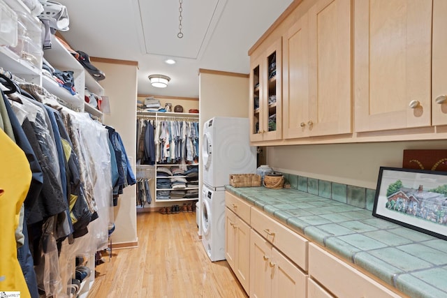 902 Altamont Rd, Greenville, SC 29609 - walk in closet featuring light wood-style floors, attic access, and stacked washing maching and dryer