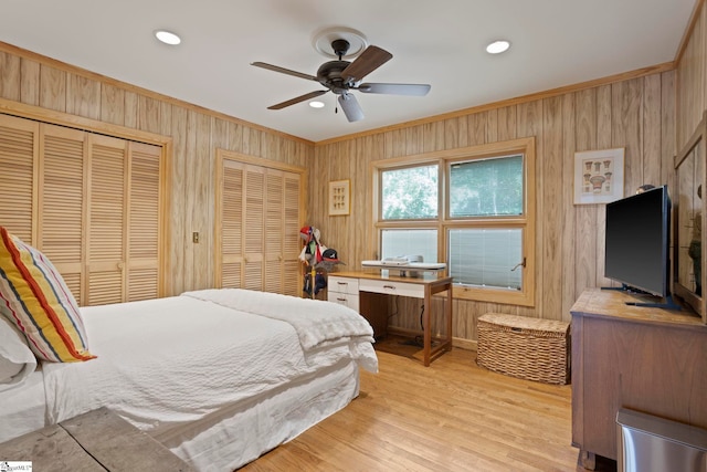 902 Altamont Rd, Greenville, SC 29609 - bedroom featuring crown molding, multiple closets, light wood-type flooring, and wooden walls