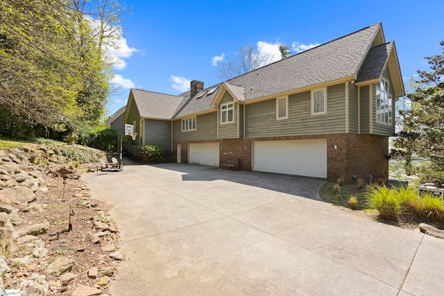 902 Altamont Rd, Greenville, SC 29609 - view of front facade featuring a shingled roof, a garage, a chimney, concrete driveway, and brick siding