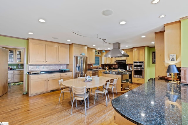 902 Altamont Rd, Greenville, SC 29609 - kitchen with tasteful backsplash, light brown cabinets, light wood-type flooring, island range hood, and stainless steel appliances