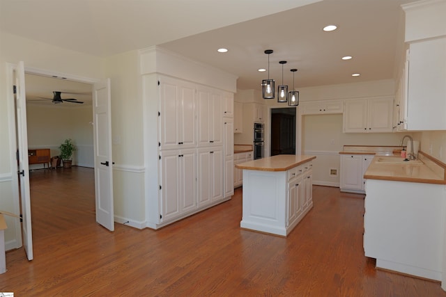 106 Carolina Club Dr, Spartanburg, SC 29306 - kitchen featuring wood finished floors, a sink, and white cabinetry