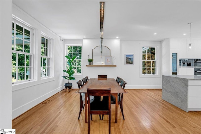 dining area featuring visible vents, baseboards, ornamental molding, light wood-style floors, and recessed lighting