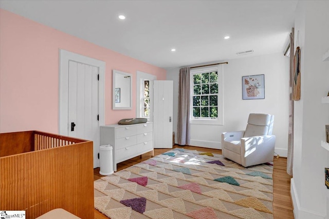 bedroom with visible vents, baseboards, recessed lighting, and wood finished floors