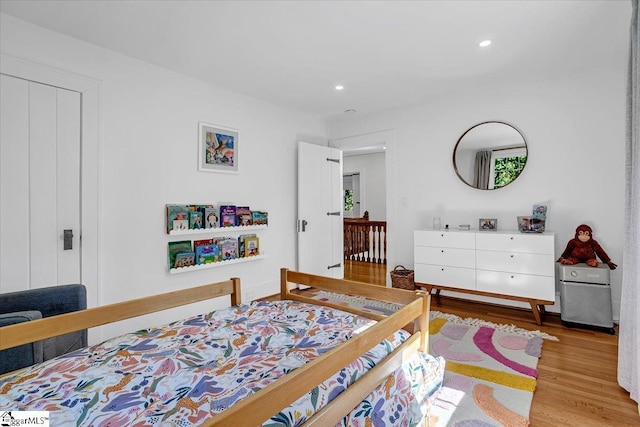 bedroom with recessed lighting and wood finished floors
