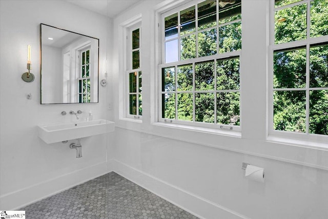 bathroom with tile patterned floors, plenty of natural light, and a sink