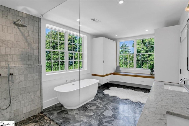 bathroom with vanity, a soaking tub, tiled shower, visible vents, and marble finish floor