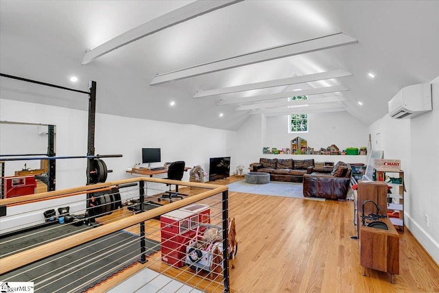 office space featuring wood finished floors, a wall mounted air conditioner, baseboards, and vaulted ceiling with beams
