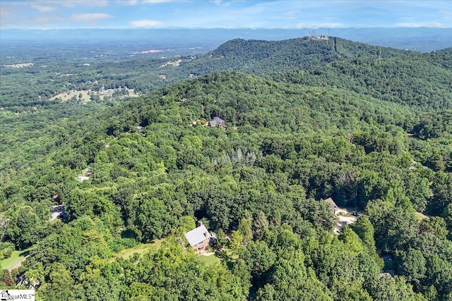 aerial view featuring a view of trees and a mountain view
