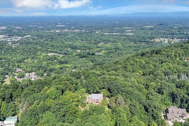 drone / aerial view with a wooded view
