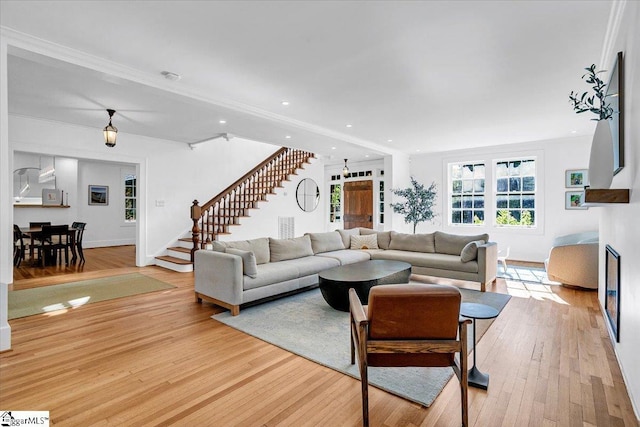 living room with recessed lighting, stairs, light wood-style flooring, and baseboards