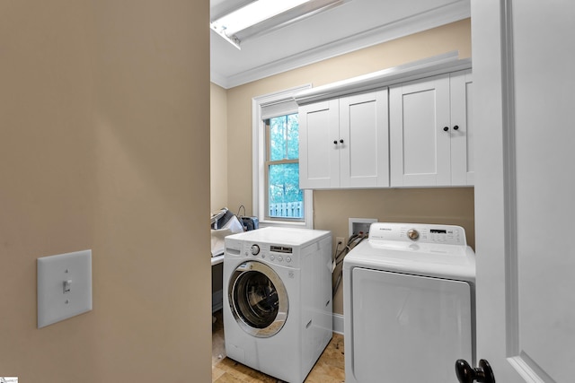 washroom with separate washer and dryer, ornamental molding, and cabinet space