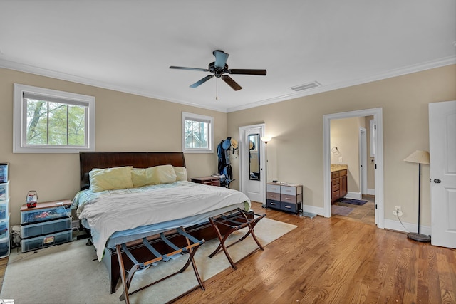 bedroom featuring visible vents, baseboards, a ceiling fan, crown molding, and light wood-style flooring