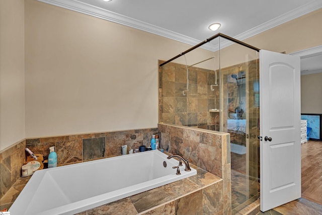 full bath with crown molding, a stall shower, and a garden tub