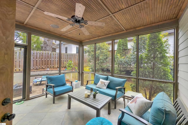 sunroom featuring a healthy amount of sunlight, an outdoor hangout area, and ceiling fan